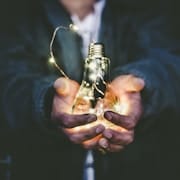 holding a light bulb for Gio Silanesu's blog Control vs Acceptance