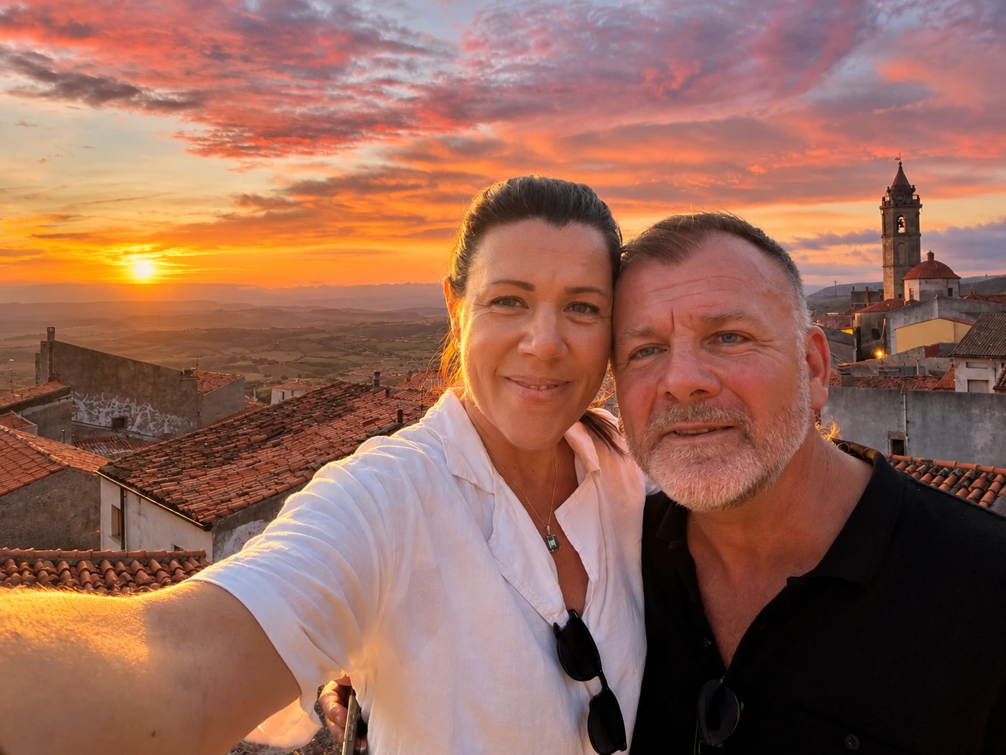 Gio and Hope with the sunset panorama of Nulvi behind them